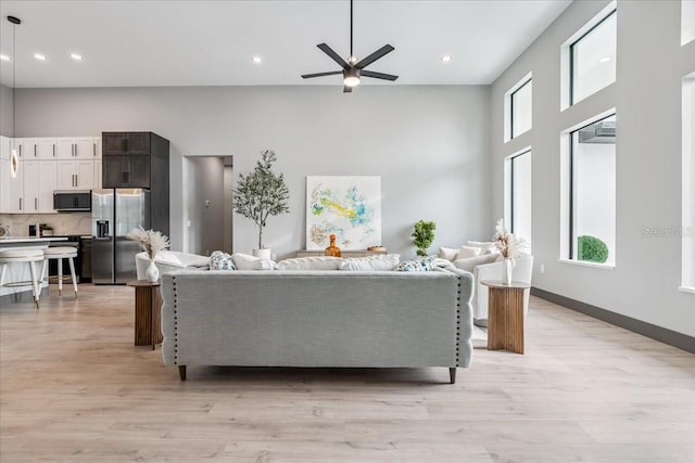 9150 Key W St, Port Charlotte, FL 33981 - living room with ceiling fan, light wood-style flooring, recessed lighting, and a high ceiling