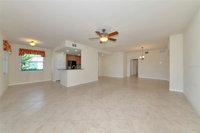 318 Winding Brook Ln Unit 104, Bradenton, FL 34212 - unfurnished living room featuring a ceiling fan, light tile patterned floors, and a chandelier