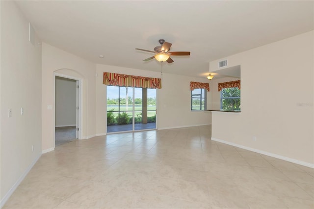 318 Winding Brook Ln Unit 104, Bradenton, FL 34212 - empty room featuring ceiling fan and arched walkways