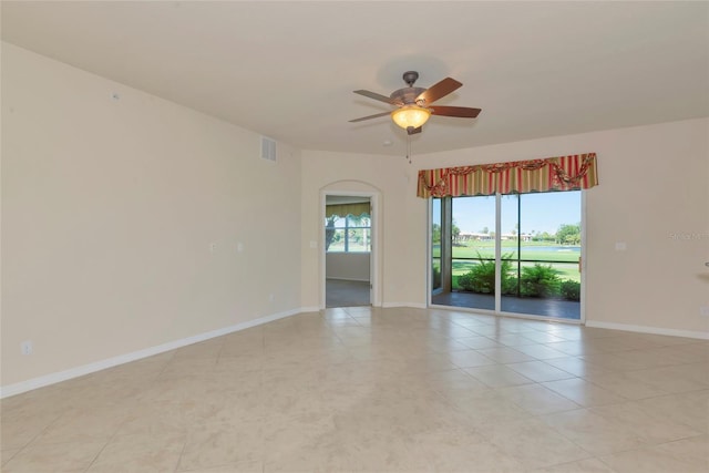 318 Winding Brook Ln Unit 104, Bradenton, FL 34212 - empty room with a ceiling fan, arched walkways, and light tile patterned floors