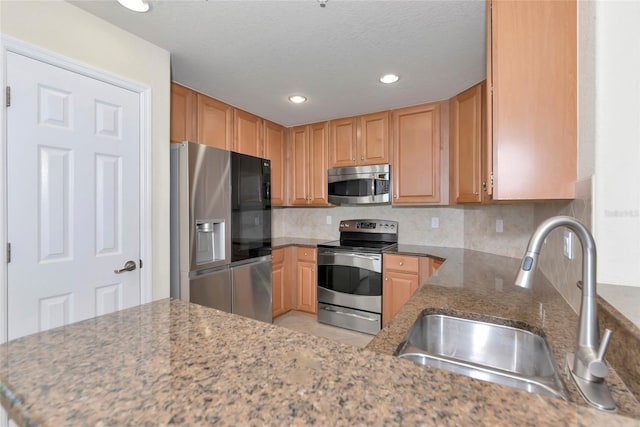 318 Winding Brook Ln Unit 104, Bradenton, FL 34212 - kitchen featuring stainless steel appliances, backsplash, stone counters, recessed lighting, and a textured ceiling