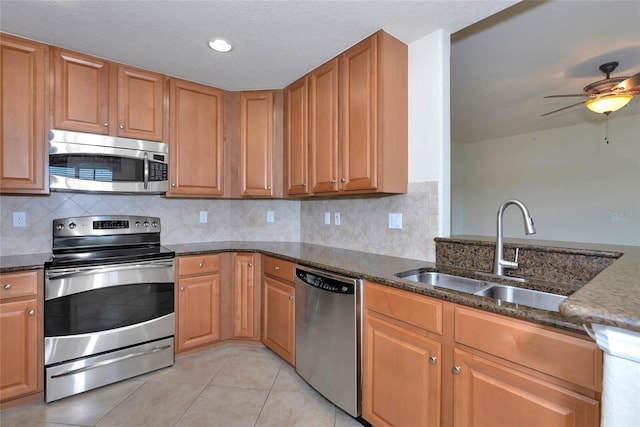 318 Winding Brook Ln Unit 104, Bradenton, FL 34212 - kitchen featuring stainless steel appliances, dark stone counters, light tile patterned floors, and recessed lighting