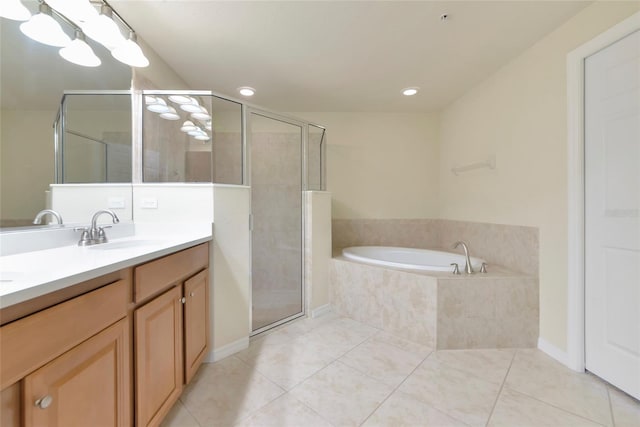 318 Winding Brook Ln Unit 104, Bradenton, FL 34212 - bathroom featuring double vanity, a garden tub, tile patterned floors, a stall shower, and recessed lighting