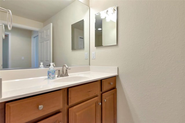 318 Winding Brook Ln Unit 104, Bradenton, FL 34212 - bathroom featuring vanity and a textured wall
