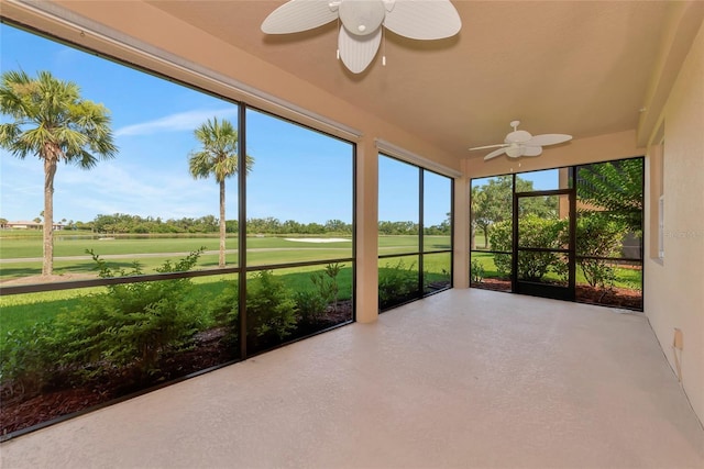 318 Winding Brook Ln Unit 104, Bradenton, FL 34212 - unfurnished sunroom featuring a ceiling fan, golf course view, and concrete flooring