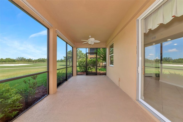 318 Winding Brook Ln Unit 104, Bradenton, FL 34212 - unfurnished sunroom featuring a ceiling fan and golf course view