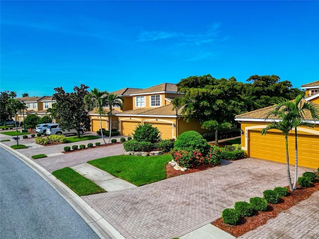 318 Winding Brook Ln Unit 104, Bradenton, FL 34212 - view of front facade featuring decorative driveway, stucco siding, and a residential view
