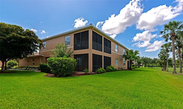 318 Winding Brook Ln Unit 104, Bradenton, FL 34212 - rear view of property featuring stucco siding and a yard