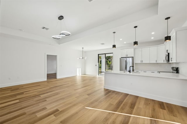 5386 Easter Ter, North Port, FL 34286 - kitchen with stainless steel appliances, light countertops, open floor plan, white cabinets, and a peninsula