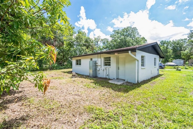 314 W Owens Ave, Arcadia, FL 34266 - rear view of property featuring a yard and stucco siding