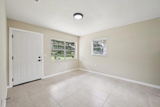 314 W Owens Ave, Arcadia, FL 34266 - unfurnished room featuring light tile patterned floors and a textured ceiling