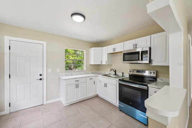 314 W Owens Ave, Arcadia, FL 34266 - kitchen with appliances with stainless steel finishes, white cabinetry, light countertops, and light tile patterned flooring