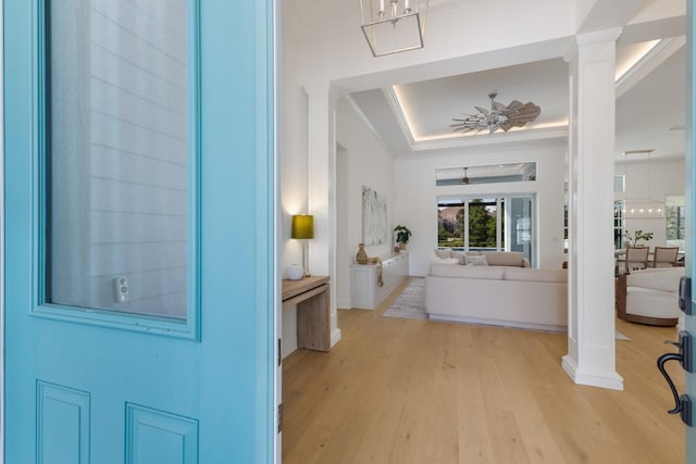 16511 Cornwall Ln, Lakewood Ranch, FL 34202 - entryway featuring ornate columns, a tray ceiling, and light wood-style flooring