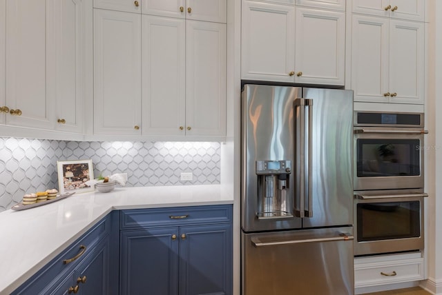 16511 Cornwall Ln, Lakewood Ranch, FL 34202 - kitchen with appliances with stainless steel finishes, blue cabinets, light countertops, and white cabinets