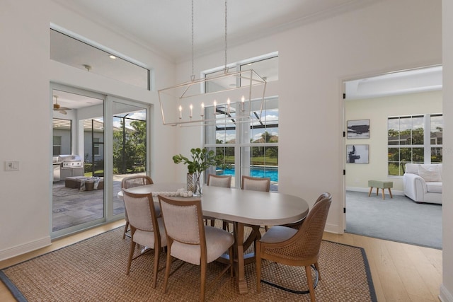 16511 Cornwall Ln, Lakewood Ranch, FL 34202 - dining room featuring light wood-style flooring, crown molding, and a chandelier