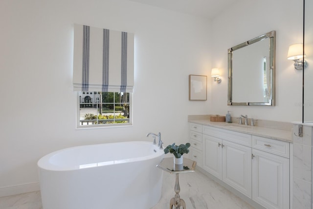 16511 Cornwall Ln, Lakewood Ranch, FL 34202 - full bathroom featuring marble look tiles, a freestanding tub, and vanity
