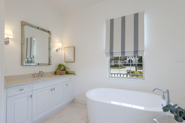 16511 Cornwall Ln, Lakewood Ranch, FL 34202 - bathroom featuring vanity, a freestanding tub, and marble finish floors