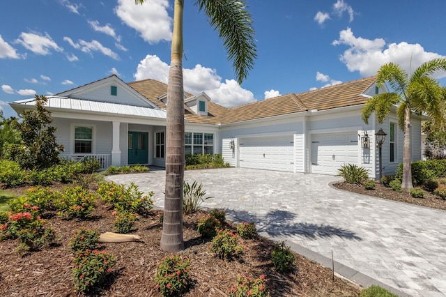 16511 Cornwall Ln, Lakewood Ranch, FL 34202 - view of front of home with a garage, decorative driveway, covered porch, and a tiled roof