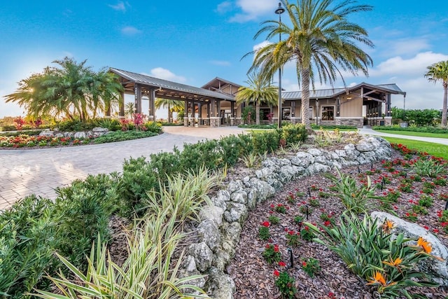 16511 Cornwall Ln, Lakewood Ranch, FL 34202 - view of front of house with stone siding, a metal roof, and a gazebo