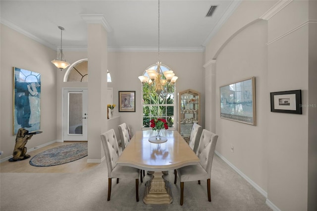 2937 Seasons Blvd, Sarasota, FL 34240 - carpeted dining room with ornate columns, ornamental molding, and a chandelier