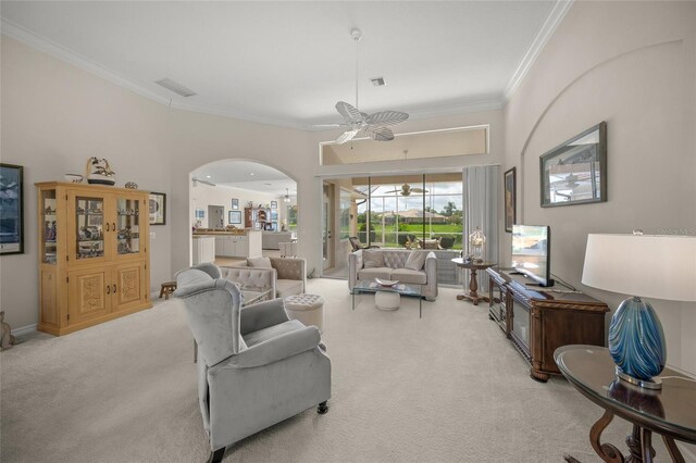2937 Seasons Blvd, Sarasota, FL 34240 - living area with a ceiling fan, light carpet, ornamental molding, and arched walkways