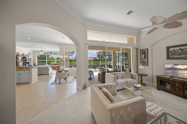 2937 Seasons Blvd, Sarasota, FL 34240 - living room featuring ceiling fan, arched walkways, crown molding, light colored carpet, and light tile patterned floors