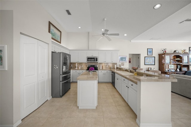 2937 Seasons Blvd, Sarasota, FL 34240 - kitchen featuring stainless steel appliances, open floor plan, a peninsula, a ceiling fan, and light countertops