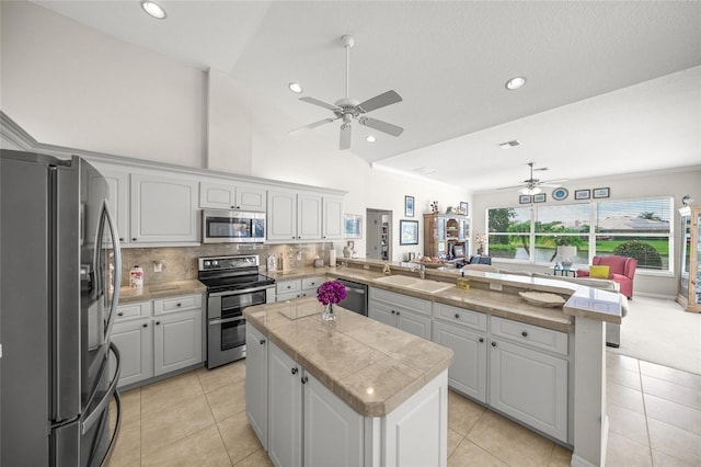 2937 Seasons Blvd, Sarasota, FL 34240 - kitchen with stainless steel appliances, open floor plan, ceiling fan, a peninsula, and a kitchen island