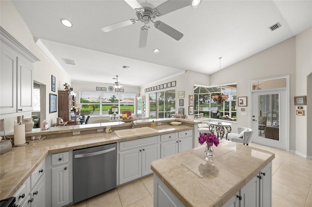 2937 Seasons Blvd, Sarasota, FL 34240 - kitchen featuring stainless steel dishwasher, a ceiling fan, light tile patterned floors, crown molding, and white cabinetry