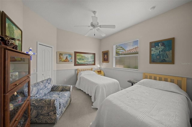 2937 Seasons Blvd, Sarasota, FL 34240 - bedroom with carpet flooring, a wainscoted wall, a closet, and a ceiling fan