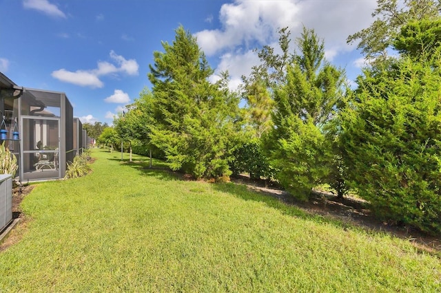 5981 Amberly Dr, Bradenton, FL 34208 - view of grassy yard with a lanai
