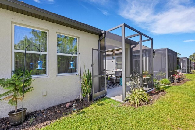 5981 Amberly Dr, Bradenton, FL 34208 - view of grassy yard with a patio area and glass enclosure