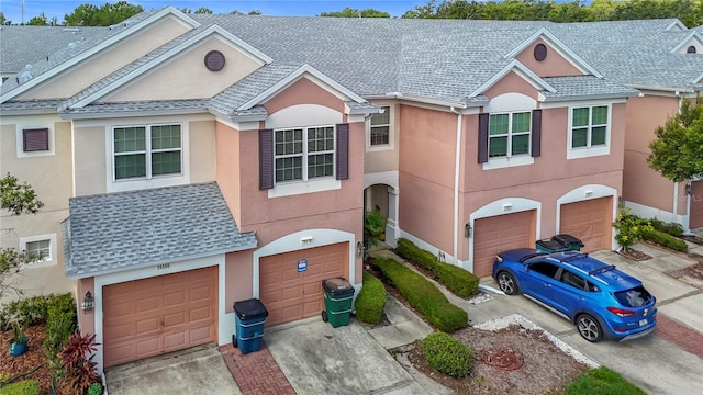 26548 Castleview Way, Wesley Chapel, FL 33544 - view of property featuring a garage, driveway, and stucco siding