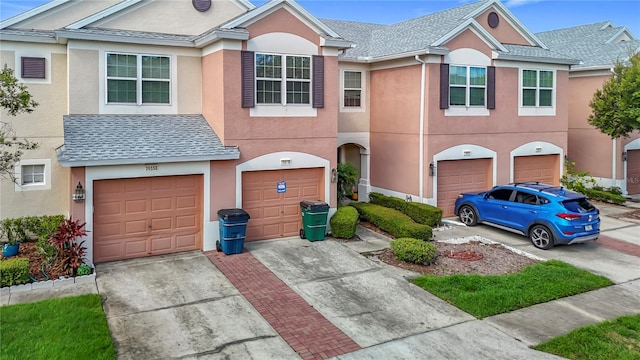 26548 Castleview Way, Wesley Chapel, FL 33544 - view of property with a garage, driveway, stucco siding, and a shingled roof