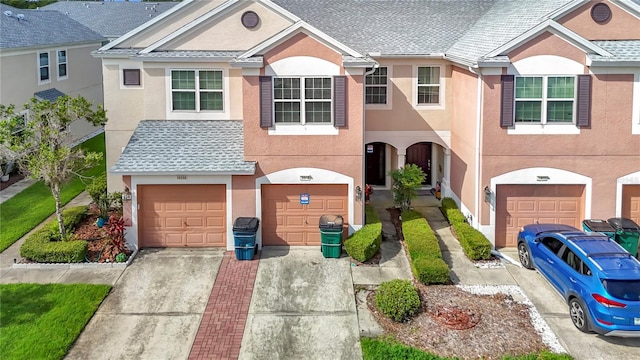 26548 Castleview Way, Wesley Chapel, FL 33544 - view of front of house with stucco siding, driveway, roof with shingles, and a garage