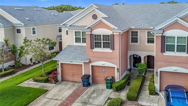 26548 Castleview Way, Wesley Chapel, FL 33544 - view of front of property with stucco siding, an attached garage, driveway, and a shingled roof