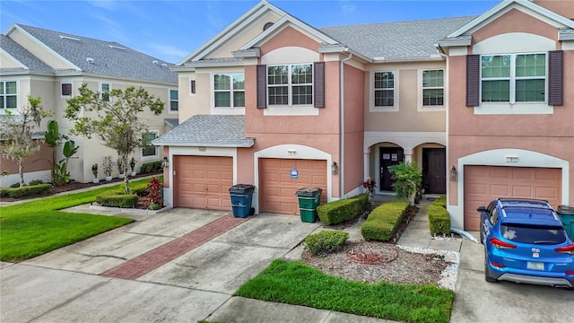 26548 Castleview Way, Wesley Chapel, FL 33544 - multi unit property with stucco siding, driveway, and a garage