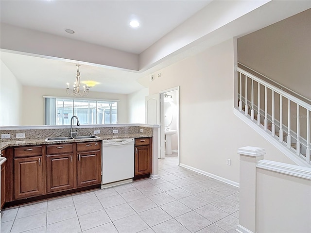 26548 Castleview Way, Wesley Chapel, FL 33544 - kitchen with white dishwasher, a chandelier, light stone countertops, light tile patterned flooring, and decorative light fixtures