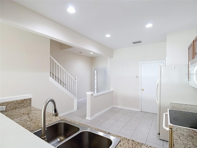 26548 Castleview Way, Wesley Chapel, FL 33544 - kitchen with light tile patterned floors, white appliances, recessed lighting, and light countertops