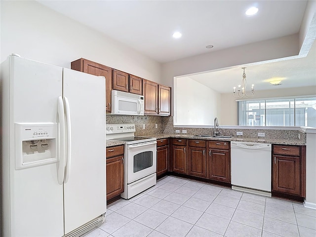 26548 Castleview Way, Wesley Chapel, FL 33544 - kitchen featuring white appliances, a chandelier, tasteful backsplash, light tile patterned floors, and recessed lighting