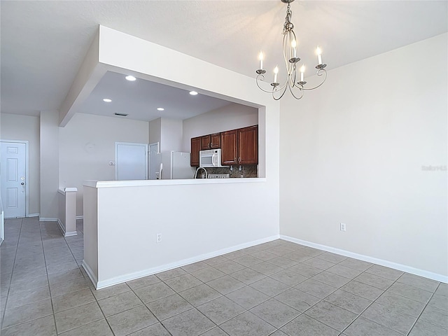 26548 Castleview Way, Wesley Chapel, FL 33544 - kitchen with white appliances, light tile patterned floors, a chandelier, recessed lighting, and decorative light fixtures