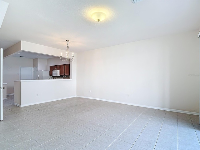 26548 Castleview Way, Wesley Chapel, FL 33544 - unfurnished living room featuring light tile patterned floors and a chandelier
