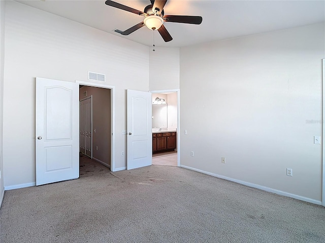 26548 Castleview Way, Wesley Chapel, FL 33544 - unfurnished bedroom with light colored carpet, a towering ceiling, ensuite bathroom, and a ceiling fan
