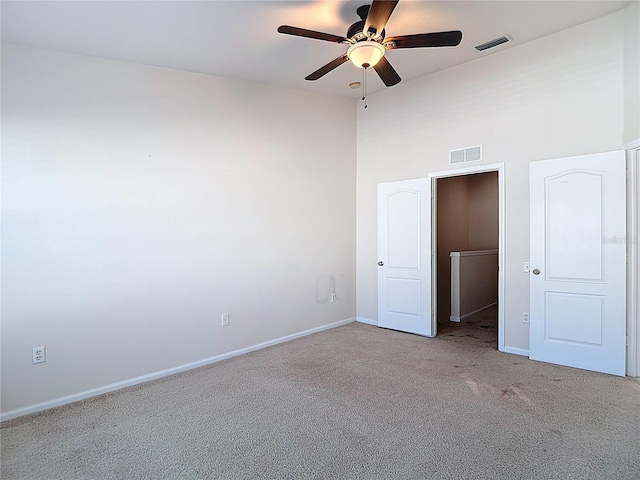 26548 Castleview Way, Wesley Chapel, FL 33544 - unfurnished bedroom featuring carpet floors, a towering ceiling, and ceiling fan