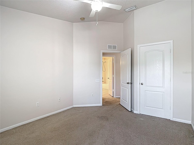 26548 Castleview Way, Wesley Chapel, FL 33544 - unfurnished bedroom with carpet floors, a textured ceiling, a ceiling fan, and a high ceiling