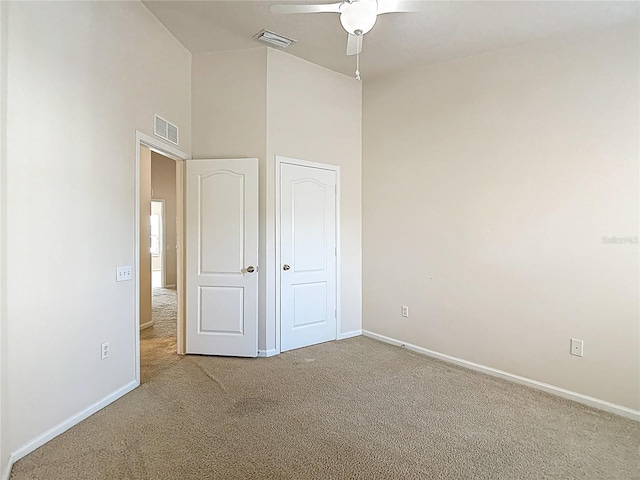 26548 Castleview Way, Wesley Chapel, FL 33544 - unfurnished bedroom featuring carpet flooring, a high ceiling, and a ceiling fan