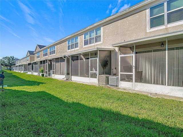 26548 Castleview Way, Wesley Chapel, FL 33544 - rear view of house featuring a lawn and a sunroom