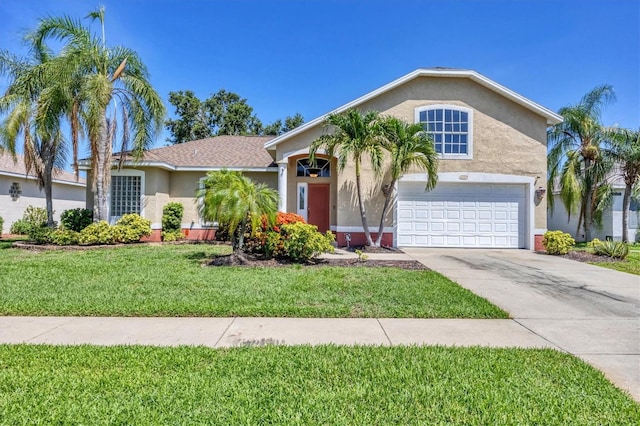 815 Greenview Dr, Apollo Beach, FL 33572 - view of front facade featuring driveway, stucco siding, a front lawn, and a garage