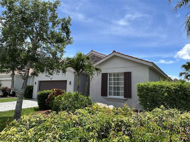 4407 67th St E, Bradenton, FL 34203 - view of front of house with an attached garage, stucco siding, and driveway