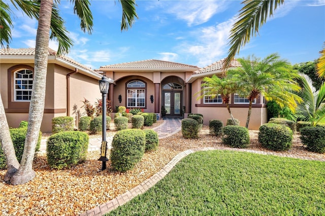 2801 SW 29th Ct, Cape Coral, FL 33914 - mediterranean / spanish home with french doors, stucco siding, and a tiled roof